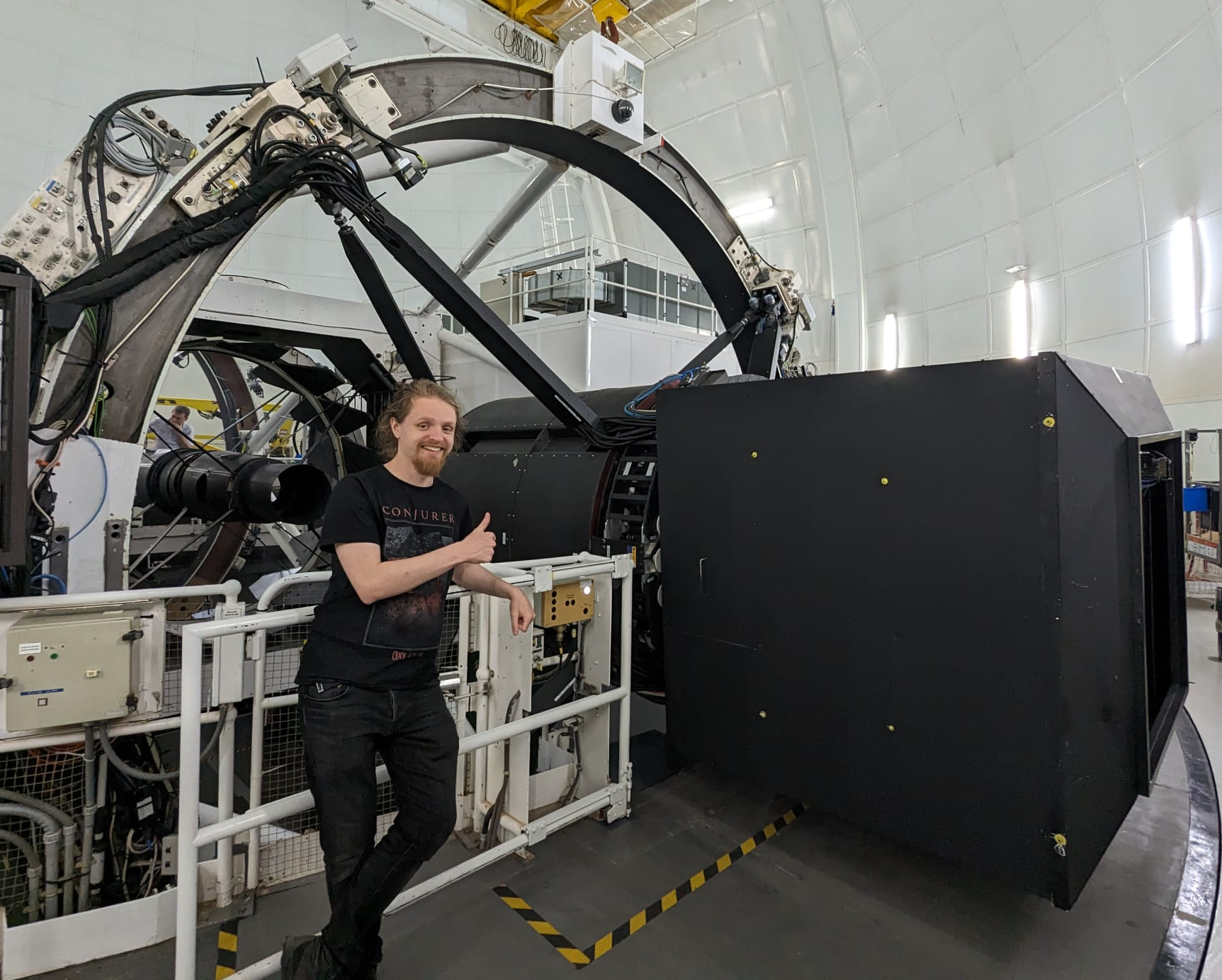 Luke R. Holden  with the WEAVE spectrograph at prime focus of the William Herschel Telescope on La Palma, Canary Islands, Spain, in May 2023.